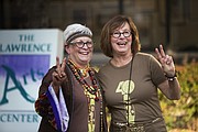 Deanell Tacha, left, and Ann Evans, right, celebrate the Lawrence Arts Center's 40th anniversary at a 70s-themed block party, Friday, Sept. 25, 2015, at 940 New Hampshire.