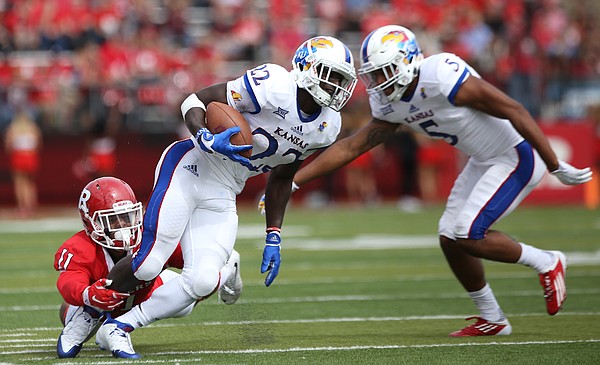Kansas running back Ke'aun Kinner (22) is snagged by Rutgers defensive back Isaiah Wharton (11) during the second quarter on Saturday, Sept. 26, 2015 at High Point Solutions Stadium in Piscataway, New Jersey. At right is Kansas wide receiver Bobby Hartzog Jr. (5).