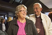 Lisa Larsen smiles after she was voted to fill the empty seat on the Lawrence City Commission on Tuesday night at City Hall. Larsen is pictured with her father, Robert Larsen, of Lawrence.