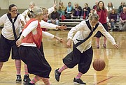 Mary Pat Pellett, right, of Lawrence, chases down a loose ball during the first game of the Granny Basketball League in Kansas Saturday evening at Holcom Park Recreational Center, 2700 W. 27th Street.