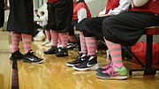 Nikes are paired with traditional 1920s women's basketball uniforms including colorful striped stockings during the first game of the Granny Basketball League in Kansas Saturday evening at Holcom Park Recreational Center, 2700 W 27th Street.