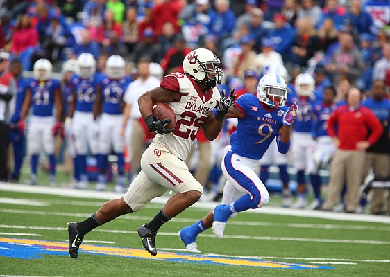 Oklahoma running back Joe Mixon (25) runs in a touchdown catch before Kansas safety Fish Smithson (9) during the first quarter, Saturday, Oct. 31, 2015 at Memorial Stadium.