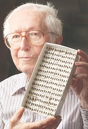 Charles Michener, a retired Kansas University biology professor, displays bees found in the rain forest. He joined in research showing that coffee plants growing near rain forests are better producers, because of the bees' pollinating efforts.