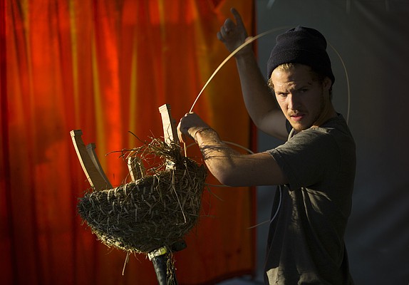 Kansas University senior Jake Kaufmann, of Omaha, Neb., works to tie bundles of straw while constructing a sun hive in Matthew Burke's Social and Sustainable Art Practices class, Tuesday, Nov. 3, 2015, in Chalmers Hall.