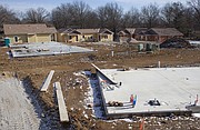 Construction is underway on Cedarwood Senior Cottages, which is being built by local nonprofit Tenants for Homeowners. It will feature 14 rent-controlled living units available for seniors who meet the necessary income guidelines. Tenants to Homeowners hopes to have six of the units ready for occupancy by about March and the other eight ready by June. The site is located at 25th Street and Cedarwood Avenue. This view is from behind the United Way building at 2518 Ridge Court looking east over foundations in the foreground and built units in the background.