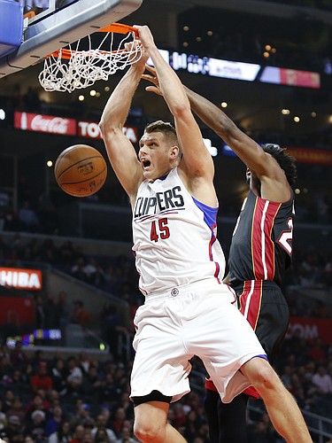 Los Angeles Clippers' Cole Aldrich, left, dunks past Miami Heat's Justise Winslow during the first half of an NBA basketball game Wednesday, Jan. 13, 2016, in Los Angeles. (AP Photo/Danny Moloshok)