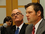 Rep. Jim Ward, left, D-Wichita, and Secretary of State Kris Kobach, a Republican, give opposing testimony to a U.S. Civil Rights Commission advisory council about the impact of Kansas' photo ID and proof of citizenship voting laws, on Jan. 29, 2016.