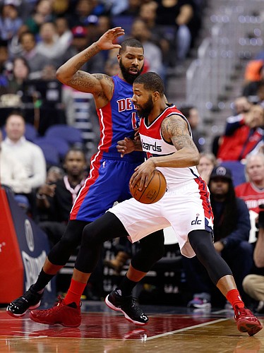 Washington Wizards forward Markieff Morris, right, drives against his twin brother, Detroit Pistons forward Marcus Morris, during the first half of an NBA basketball game Friday, Feb. 19, 2016, in Washington. (AP Photo/Alex Brandon)