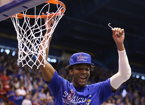 Kansas guard Devonte' Graham (4) holds up his share of the net as Jayhawks celebrate locking up a share of their twelfth-straight Big 12 title following their 67-58 win over the Red Raiders, Saturday, Feb. 27, 2016 at Allen Fieldhouse.