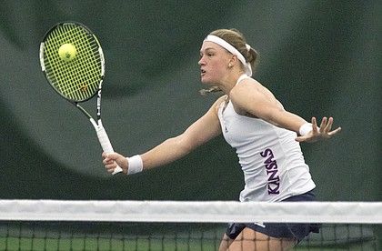 Kansas freshman Nina Khmelnitckaia reaches for a volley during her number one doubles match against New Mexico Sunday afternoon at the Jayhawk Tennis Center.
