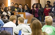 Jameelah Jones, center, and Katherine Rainey, right, speak to the Kansas University Student Senate about a proposed Multicultural Student Government fee during the Student Senate meeting Wednesday evening March 9, 2016, at the Kansas Union.