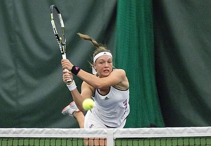 Kansas freshman Nina Khmelnitckaia hits a return volley during her number one doubles match against Texas on Friday at the Jayhawk Tennis Center.