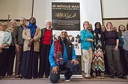 Jameel Syed, center, poses for a photograph with members of the audience after speaking about building interfaith relationships Sunday morning at Trinity Lutheran Church, 1245 New Hampshire St. In 2015, Syed, a Muslim, became the first person to recite the Adhan, or Islamic Call to Prayer, along with the last sermon of the Prophet Muhammad in all 50 states in only 35 days.