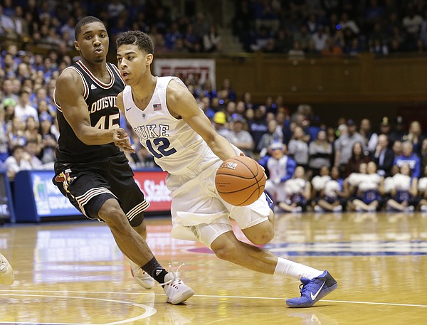 Louisville's Donovan Mitchell (45) guards Duke's Derryck Thornton (12) during the second half of an NCAA college basketball game in Durham, N.C., Monday, Feb. 8, 2016. Duke won 72-65. (AP Photo/Gerry Broome)