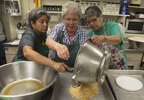 From left, Judy Romero, Bertha Bermudez and Val Howland spread some rice out to cool to be used to make sopa in preparation for this weekend’s annual St. John’s Mexican Fiesta. The fiesta will be held from 6-11:30 p.m. Friday and Saturday at St. John the Evangelist Catholic Church, 1234 Kentucky St.
