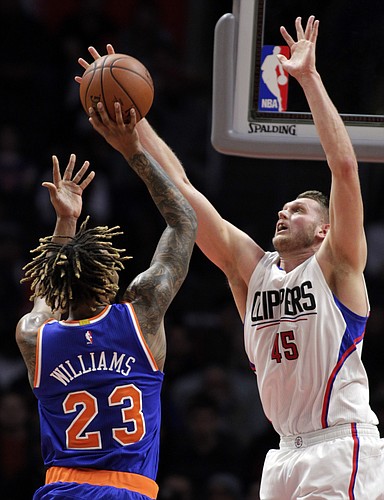 Los Angeles Clippers center Cole Aldrich (45) blocks a shot by New York Knicks forward Derrick Williams (23) during the first half of an NBA basketball game in Los Angeles, Friday, March 11, 2016. (AP Photo/Alex Gallardo)