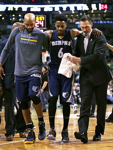 Memphis Grizzlies guard Mario Chalmers (6) is helped from the court after injuring his right leg during the third quarter of an NBA basketball game against the Boston Celtics in Boston, Wednesday, March 9, 2016. (AP Photo/Charles Krupa)
