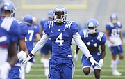 Kansas receiver Daylon Charlot soars back to get in line during team stretches at the beginning of practice on Monday, Aug. 15, 2016 at Memorial Stadium.