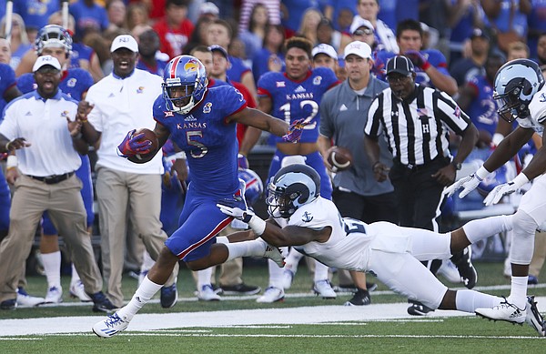 Kansas wide receiver Bobby Hartzog Jr. (5) avoids a tackle from Rhode Island safety Nas Jones (27) after a catch during the first quarter on Saturday, Sept. 3, 2016 at Memorial Stadium.