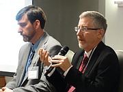 Chris Courtwright, right, an economist with the Kansas Legislature's Research Department, and Wichita State University researcher Jeremy Hill speak Thursday at the Kansas Economic Policy Conference at the University of Kansas, an annual event hosted by KU's Institute for Policy and Social Research.