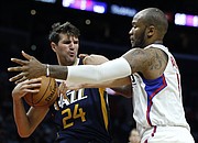 Utah Jazz center Jeff Withey (24) pulls away a rebound from Los Angeles Clippers center Marreese Speights (5) during the second half of an NBA preseason basketball game in Los Angeles, Monday, Oct. 10, 2016. The Jazz won 96-94. (AP Photo/Alex Gallardo)