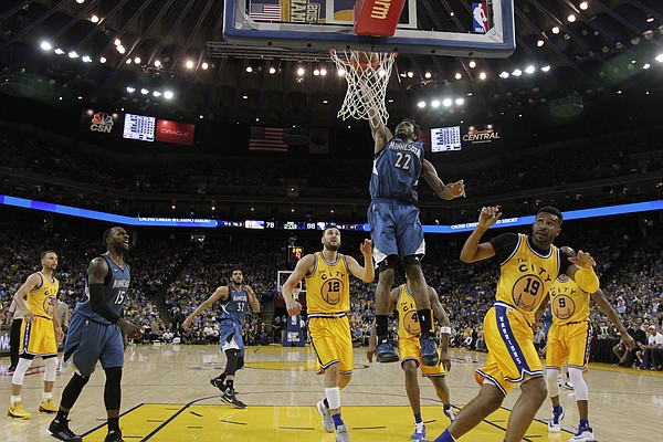 Minnesota Timberwolves' Andrew Wiggins (22) dunks against the Golden State Warriors during the second half of an NBA basketball game Tuesday, April 5, 2016, in Oakland, Calif. Minnesota won 124-117 in overtime. (AP Photo/Marcio Jose Sanchez)
