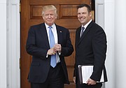 President-elect Donald Trump pauses to pose for photographs as he greets Kansas Secretary of State, Kris Kobach, at the Trump National Golf Club Bedminster clubhouse, Sunday, Nov. 20, 2016, in Bedminster, N.J.. (AP Photo/Carolyn Kaster)