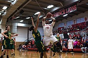 Lawrence High sophomore Chisom Ajekwu (45) goes up strong over Shawnee Mission South defender Robyn Macdonald (20) in the sub-state title game Saturday at LHS.