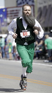 Mike Ostrekko, Lawrence, competes in the Ad Astra Irish Mile race through downtown on Friday afternoon, March 17, 2017.