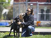 Two dogs, Fritz, left, and Socks clamor for attention from behavior manager Amy Ogleby on Monday, April 10, 2017 in the play yard at the Lawrence Humane Society, 1805 E. 19th St.