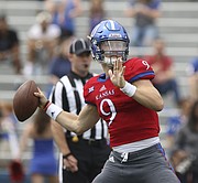Kansas redshirt sophomore quarterback Carter Stanley pulls back to throw during the spring game, on Saturday, April 15, at Memorial Stadium.