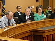 Sen. Jim Denning, center, tells the Senate Select Committee on Education Finance that a surcharge on utility bills is needed to fund an increase in education funding because sales tax revenues that go into the state general fund have been declining, mainly due to increased online shopping.