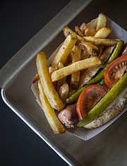 The Chicago dog at Leeway Franks, 935 Iowa St., is an all-beef frankfurter served with yellow mustard, green relish, diced onions, a pickle spear, tomatoes and sport peppers on a poppy seed bun and topped with celery salt.
