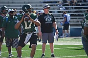 Free State quarterback Jordan Preston (17) looks downfield for a pass during the University of Kansas football team camp at Memorial Stadium on June 5, 2017.