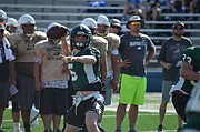 Free State quarterback Gage Foster (5) prepares to fire a pass during a scrimmage at the University of Kansas football team camp at Memorial Stadium on June 5, 2017.