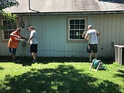 Volunteers organized by the Lawrence Professional Firefighters Charitable Foundation work on the Lawrence house of Irma Blair. Blair is the widow of Mark Blair, a Lawrence firefighter who was killed on duty in 1986.