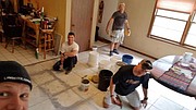 Volunteers organized by the Lawrence Professional Firefighters Charitable Foundation work on the Lawrence house of Irma Blair. Blair is the widow of Mark Blair, a Lawrence firefighter who was killed on duty in 1986.