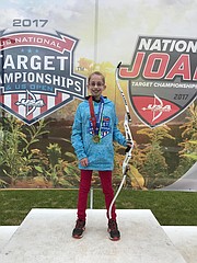 Adriana Cain, a Chicago resident and sixth-grader at Lawrence Virtual School, earned first- and second-place scores at the U.S.A. Archery Outdoor National Championships in August 2017 in Indianapolis. She is shown here with her bow.