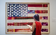 Free State junior Makayla Zolman studies Faith Ringgold&squot;s "Flag Story Quilt" during a tour of the Spencer Museum of Art on Tuesday, Aug. 22, 2017.