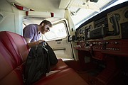 Austin Pyle, of Mission, removes his things from inside a plane after flying on Tuesday, Aug. 29, 2017 at the Vinland Valley Aerodrome.