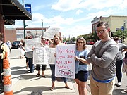 Protestors line the sidewalks in downtown Tonganoxie on Tuesday, Sept. 5, 2017, as Tyson Foods, Inc., announces plans to build a $320 million poultry processing plant near the town that will employ up to 1,600 people, processing as many as 1.25 million birds per week.