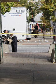 Investigators were busy working the scene of a multiple fatality shooting midday Sunday, Oct. 1, 2017. The entire intersection of 11th and Massachusetts streets was closed while investigators gathered evidence.