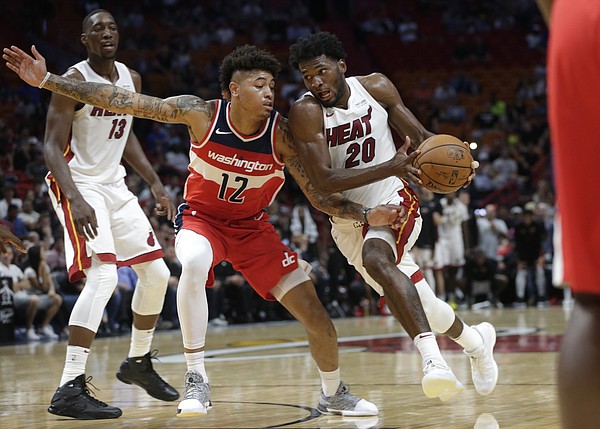 Miami Heat's Justise Winslow (20) drives to the basket as Washington Wizards' Kelly Oubre Jr. (12) defends during the second half of a preseason NBA basketball game, Wednesday, Oct. 11, 2017, in Miami. The Heat won 117-115. (AP Photo/Lynne Sladky)
