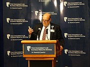 Bob Page, president and CEO of the University of Kansas Health System, announces the completion of a purchase of St. Francis Health Center in Topeka in a partnership with Ardent Health Services of Nashville. The 378-bed facility was in danger of closing earlier this year because of financial troubles.