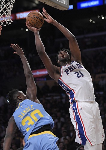 Philadelphia 76ers center Joel Embiid, right, shoots as Los Angeles Lakers forward Julius Randle defends during the second half of an NBA basketball game, Wednesday, Nov. 15, 2017, in Los Angeles. The 76ers won 115-109. (AP Photo/Mark J. Terrill)
