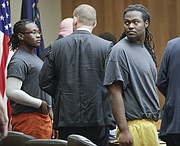 Ramone Singleton, right, turns to look at the gallery at the end of a preliminary hearing on Tuesday, Nov. 21, 2017, in Douglas County District Court. Singleton is one of three men charged with murder and other crimes in connection with a Sept. 2, 2017 shooting at the North Lawrence Motel 6. Also pictured, at left, is co-defendant Tyrone J. Carvin with his appointed defense attorney, Michael Clarke, center.