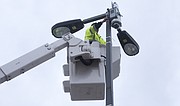In this file photo from March 23, 2016, a city employee installs a temporary surveillance camera near Ninth and Massachusetts streets. Temporary cameras are sometimes installed to oversee areas where large crowds are expected, such as Final Four celebrations downtown, though those cameras are removed after events.