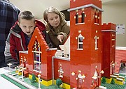 Sid, 7, and Grace Adams, 11, of Baldwin, check out a Lego representation of St. Luke AME church, 900 New York St., before the start of One Dream Martin Luther King, Jr. Community Celebration hosted by the Lawrence Public Schools on Thursday, Jan. 21, 2016, at South Middle School.