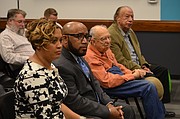 Anthony Lewis, second from left, and his wife Tiffany Lewis, far left, listen to a speaker at the Lawrence school board meeting on Monday, Jan. 29, 2018 at the USD 497 district headquarters. Anthony Lewis was approved as the district's next superintendent at the meeting.
