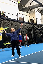 Grace Endacott Brooks, 85, of Lawrence, tosses a tennis ball into the air as she works on her serve during class Feb. 2, 2018 at the Jayhawk Tennis Center, 233 Rock Chalk Lane.
